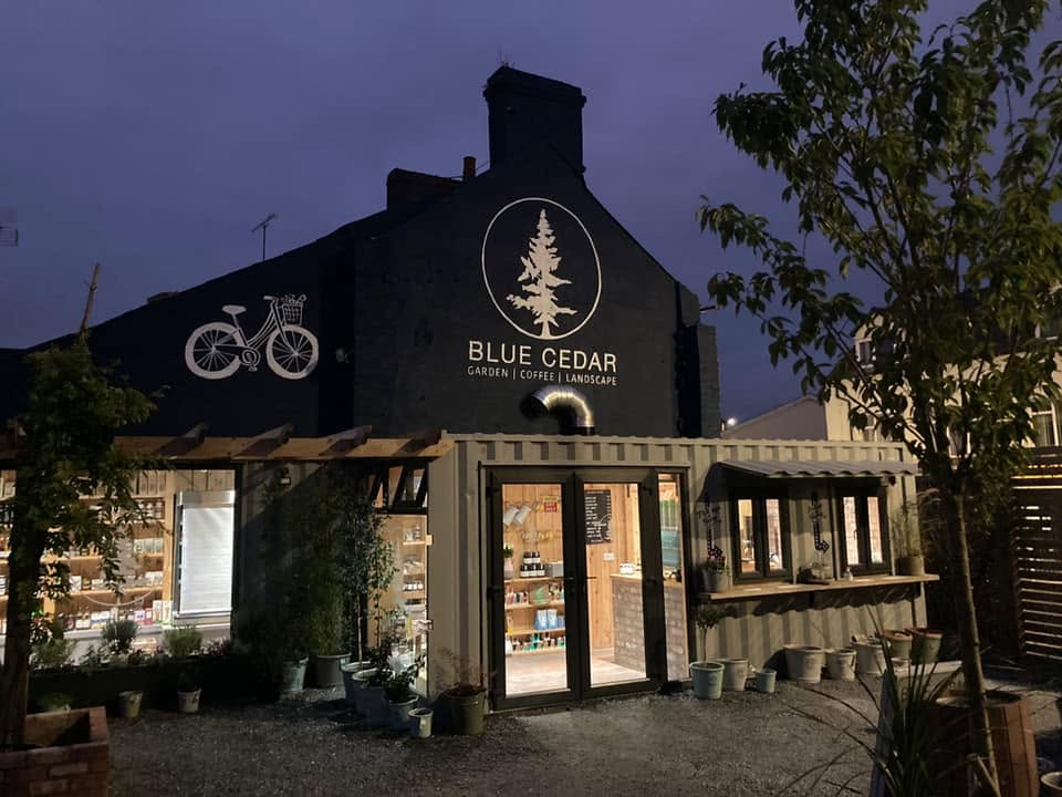 Blue Cedar mural and entrance on High Street at dusk