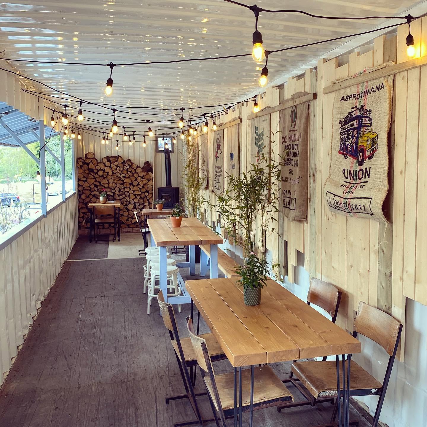 Indoor seating with warm lighting and a wood stove